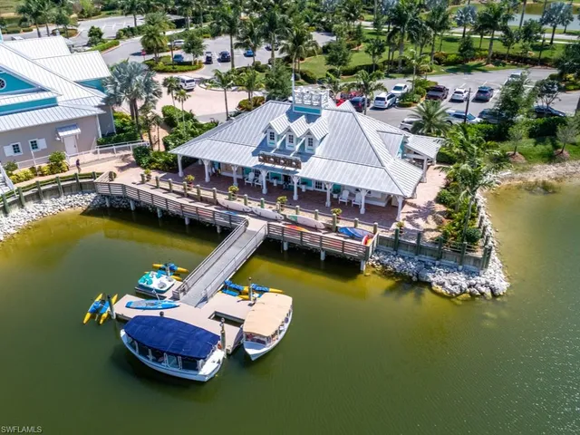 an aerial view of a house with a table swimming pool and outdoor seating