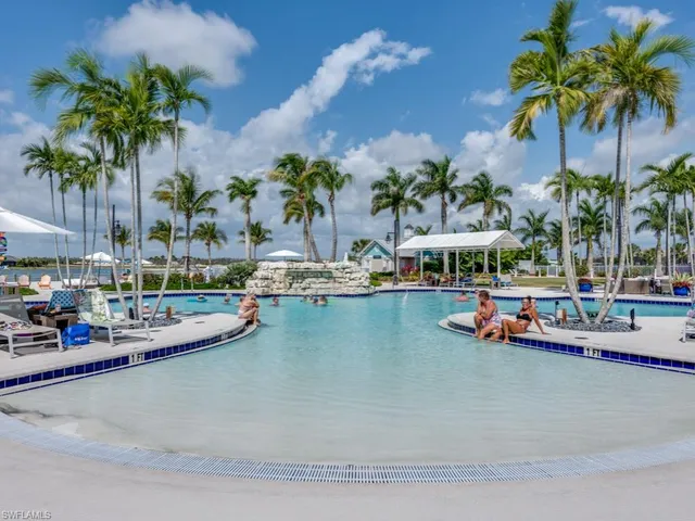 a patio with a table and chairs and potted plants