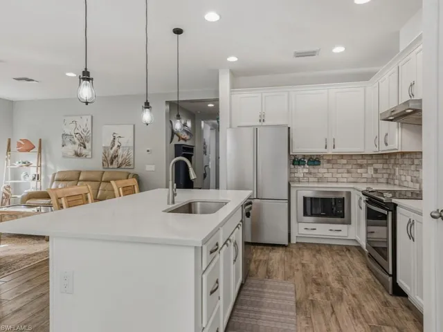a kitchen with a sink stove and refrigerator