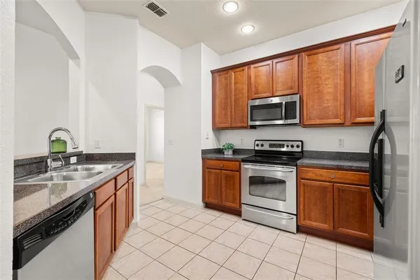 a kitchen with a sink stove and microwave