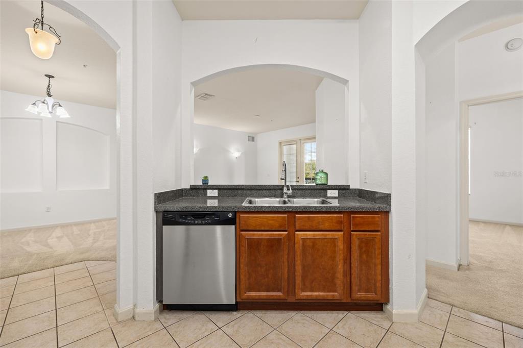 3025 Greystone Loop, Unit 204 Kissimmee, FL 34741 - Photo 13 of 37 a kitchen with a sink and cabinets