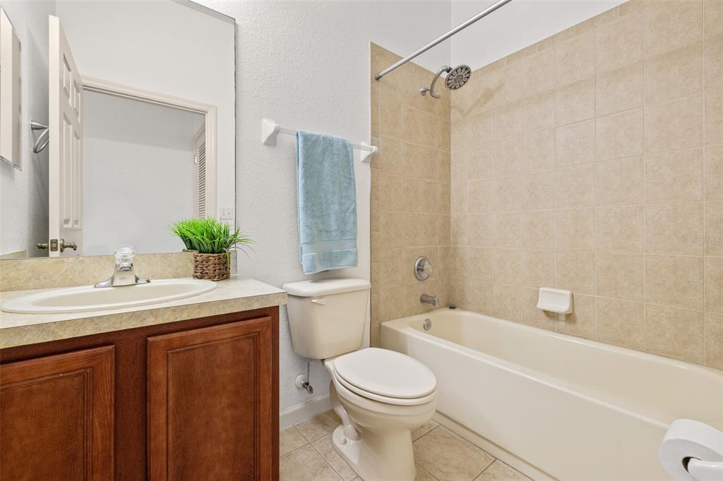 3025 Greystone Loop, Unit 204 Kissimmee, FL 34741 - Photo 19 of 37 a bathroom with a sink a toilet and shower