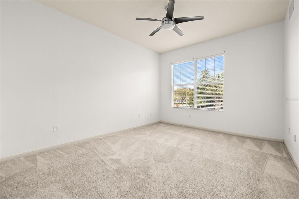 3025 Greystone Loop, Unit 204 Kissimmee, FL 34741 - Photo 20 of 37 an empty room with windows and fan