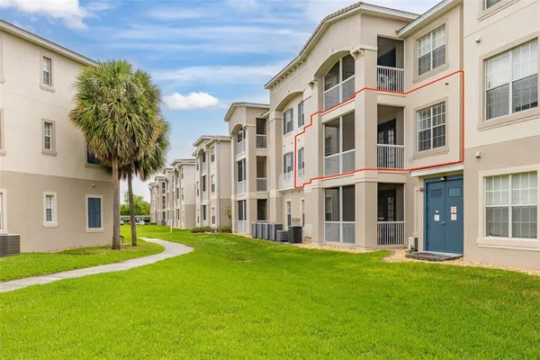 a large building with a big yard and more windows