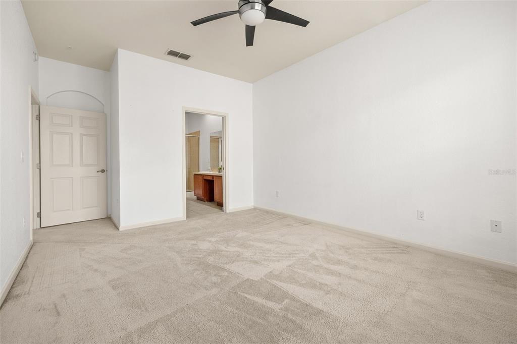 3025 Greystone Loop, Unit 204 Kissimmee, FL 34741 - Photo 21 of 37 an empty room with a ceiling fan and a window