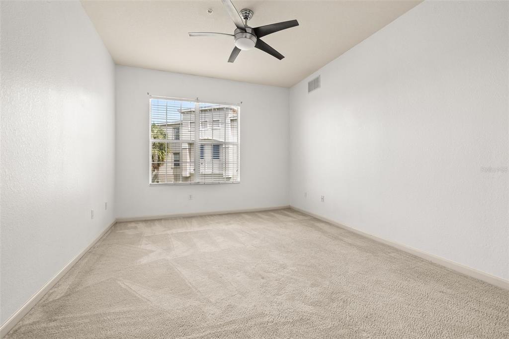 3025 Greystone Loop, Unit 204 Kissimmee, FL 34741 - Photo 22 of 37 an empty room with windows and fan