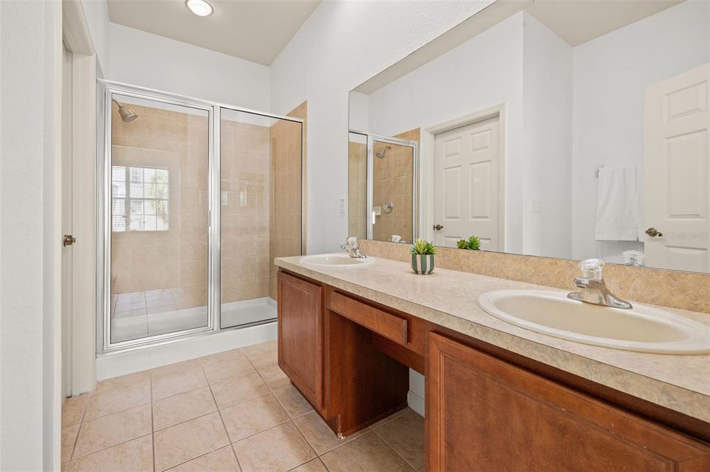3025 Greystone Loop, Unit 204 Kissimmee, FL 34741 - Photo 23 of 37 a bathroom with a granite countertop sink and a mirror