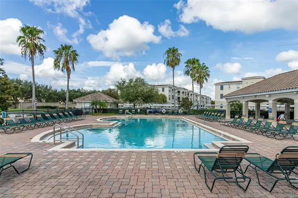 a view of a swimming pool with a lounge chairs