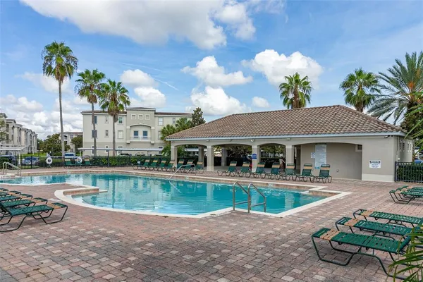 a front view of a house with swimming pool having outdoor seating