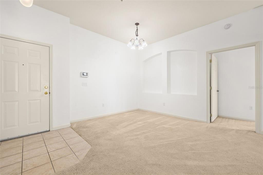 3025 Greystone Loop, Unit 204 Kissimmee, FL 34741 - Photo 6 of 37 a view of an empty room with chandelier fan