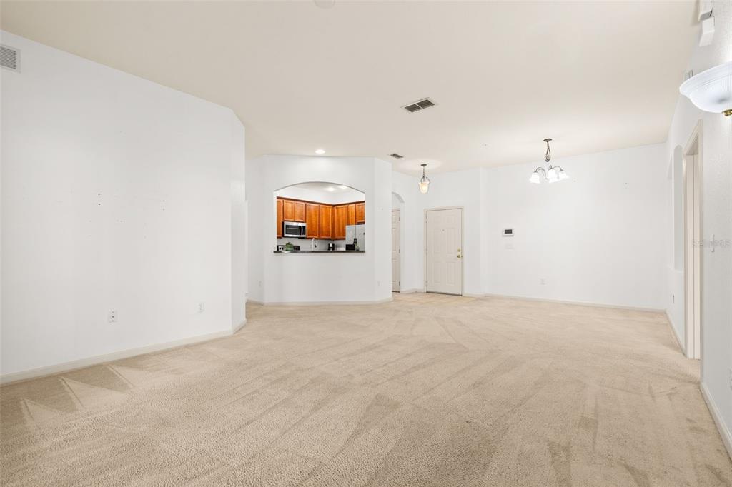 3025 Greystone Loop, Unit 204 Kissimmee, FL 34741 - Photo 9 of 37 a view of an empty room and a kitchen