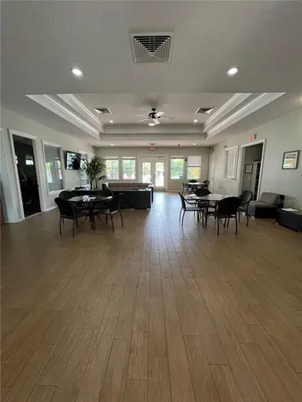 a living room with lots of furniture and a wooden floor