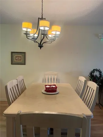 a view of a dining room with a table and chairs