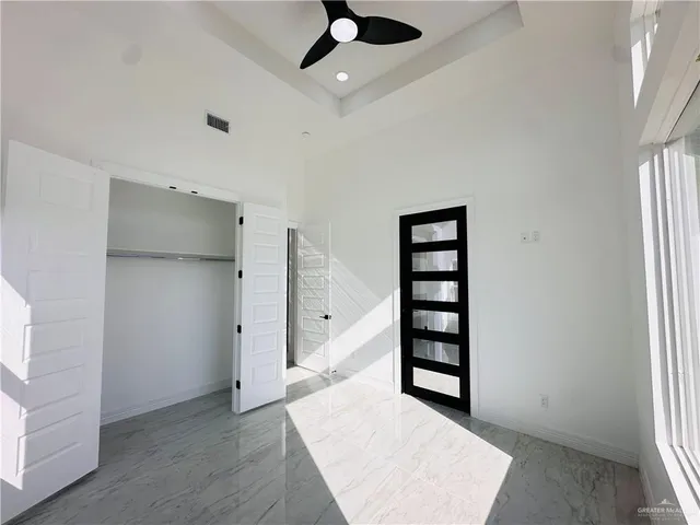 a bathroom with a sink a toilet a mirror and shower