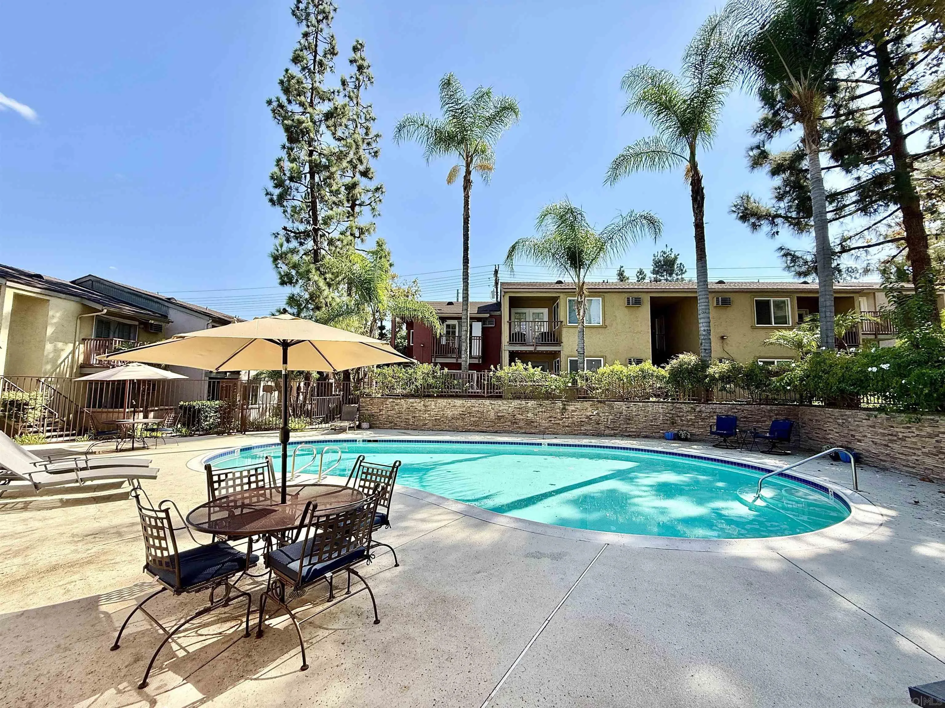 1280 West Main Street, Unit 3 El Cajon, CA 92020 - Photo 1 of 29 a view of a patio with a table and chairs under an umbrella