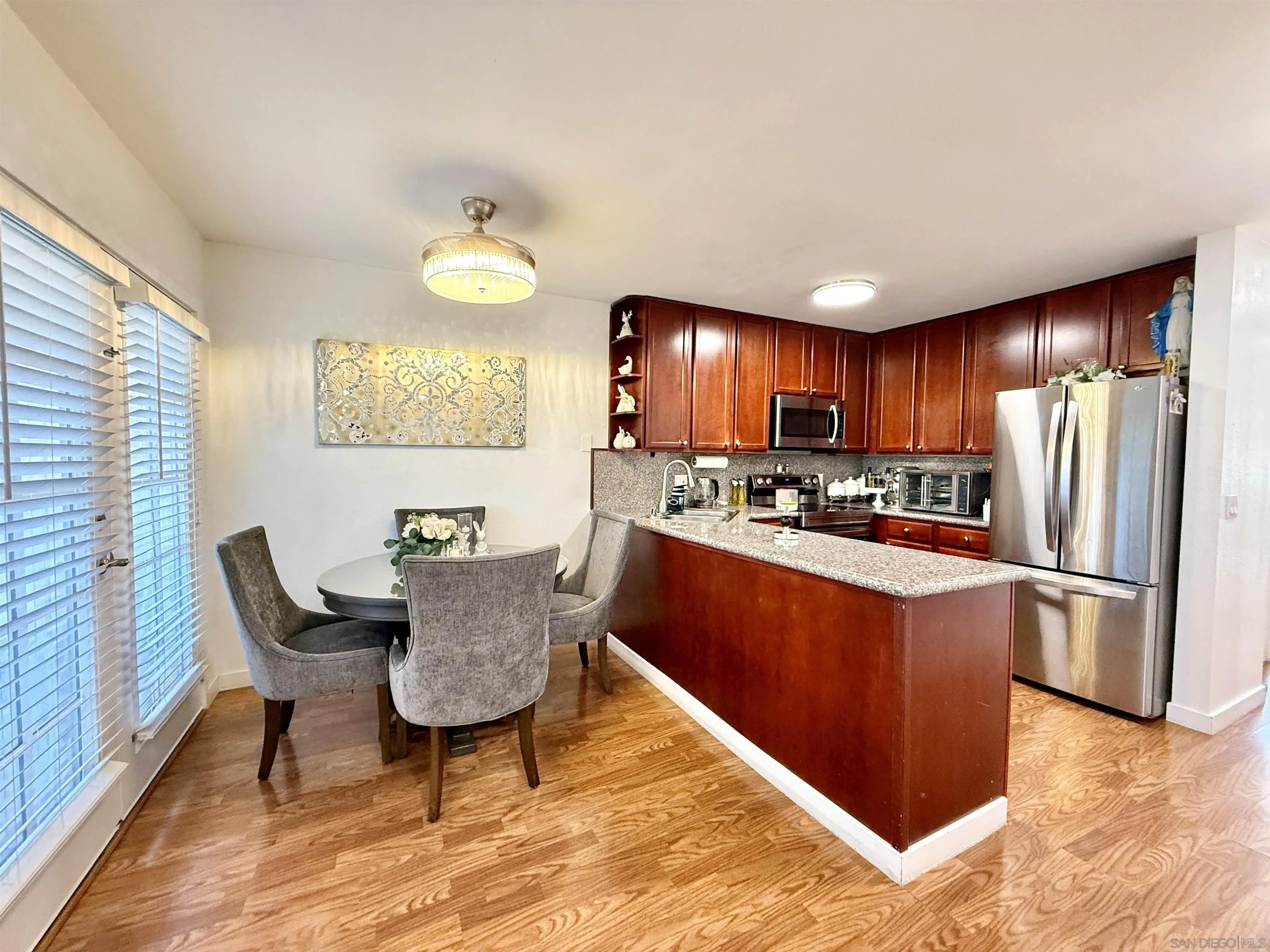 1280 West Main Street, Unit 3 El Cajon, CA 92020 - Photo 12 of 29 a kitchen with stainless steel appliances granite countertop a refrigerator a stove top oven a sink dishwasher and wooden cabinets