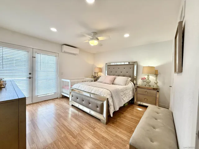 a bedroom with a bed and closet with wooden floor