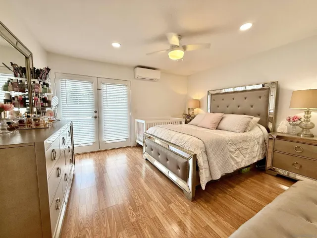 a bedroom with a bed dresser and a window