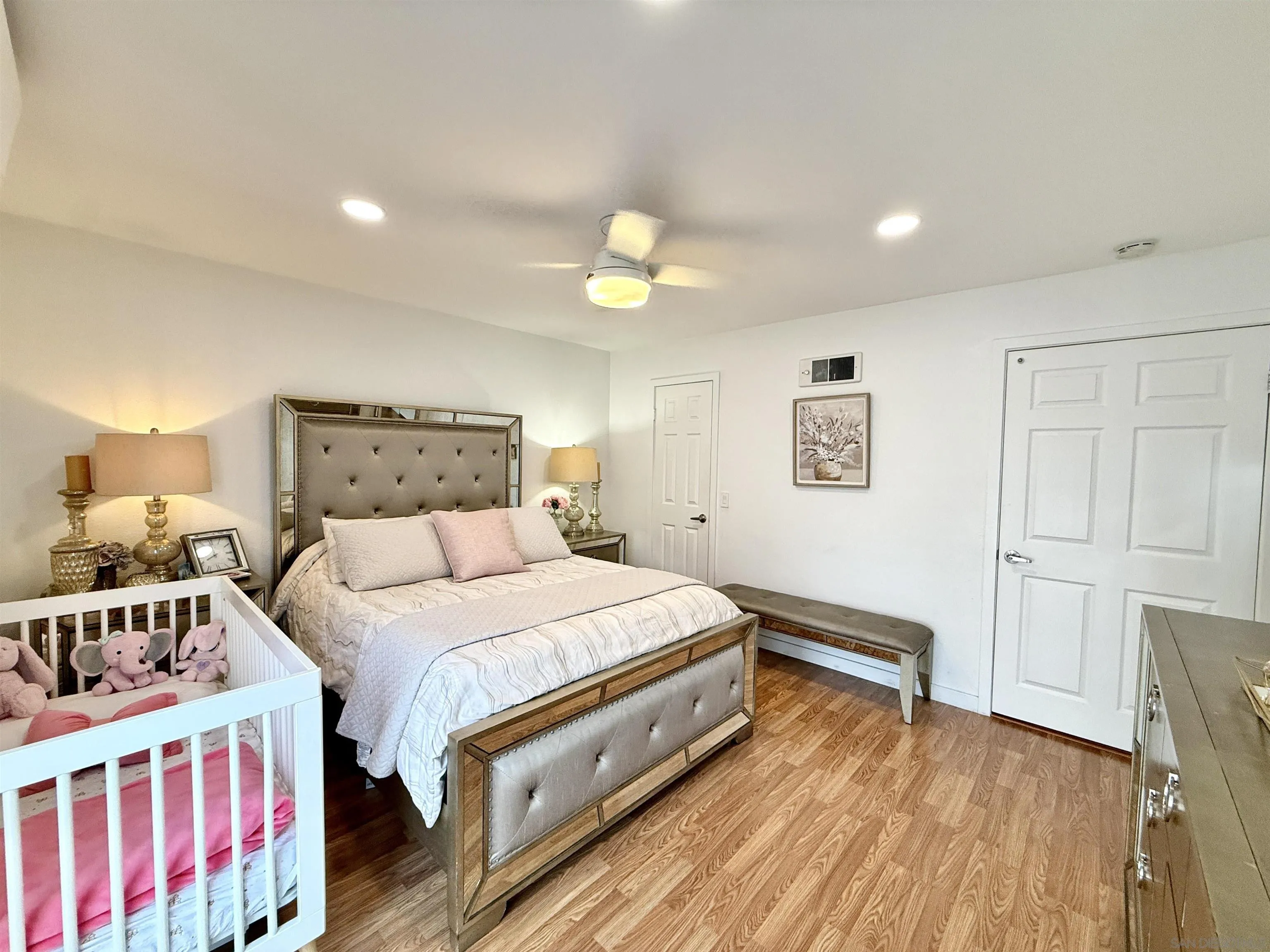 1280 West Main Street, Unit 3 El Cajon, CA 92020 - Photo 16 of 29 a bedroom with a bed and a chandelier