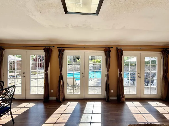 a living room with furniture and large windows