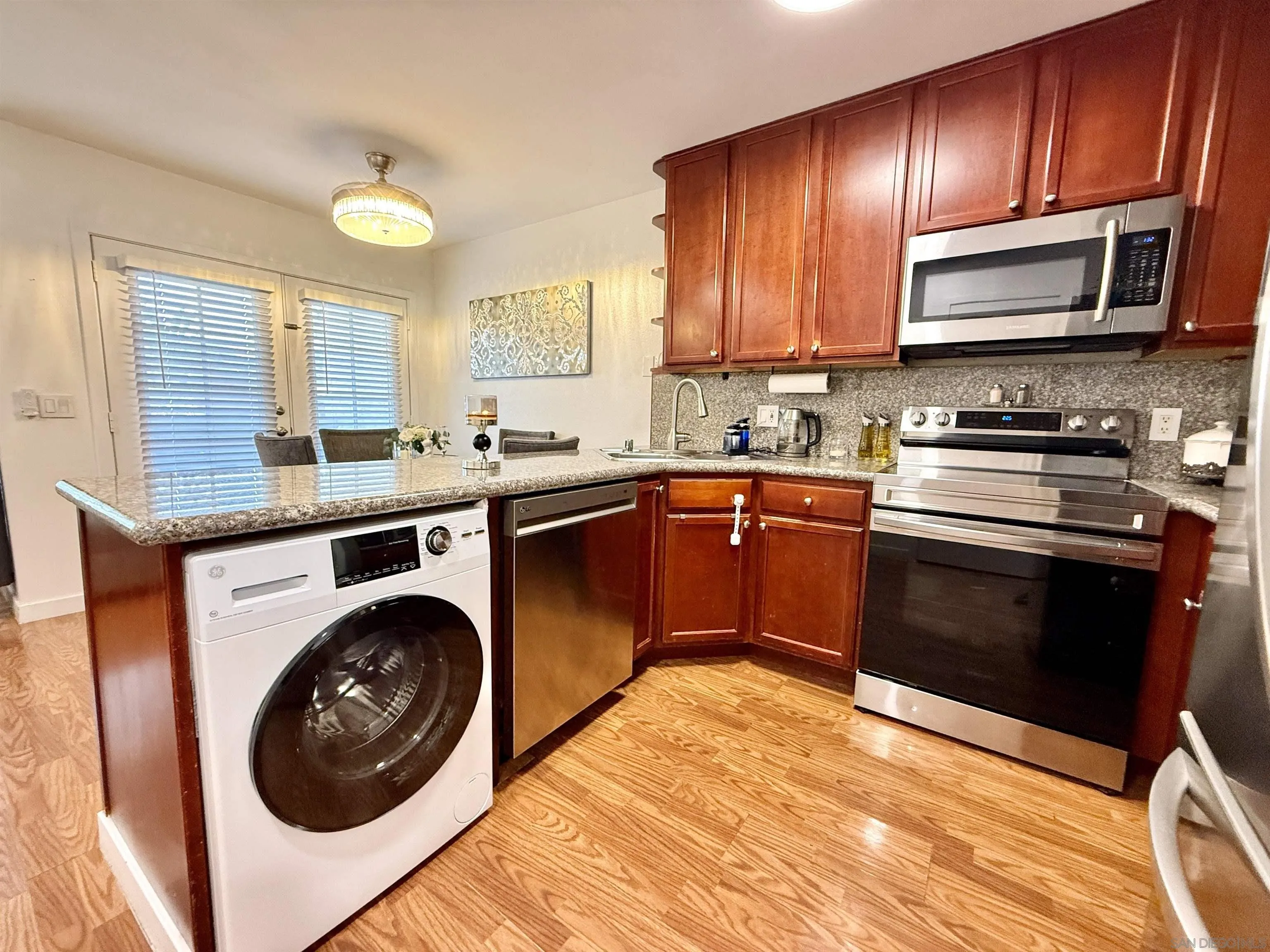 1280 West Main Street, Unit 3 El Cajon, CA 92020 - Photo 3 of 29 a kitchen with stainless steel appliances granite countertop wooden cabinets a stove a sink and a oven