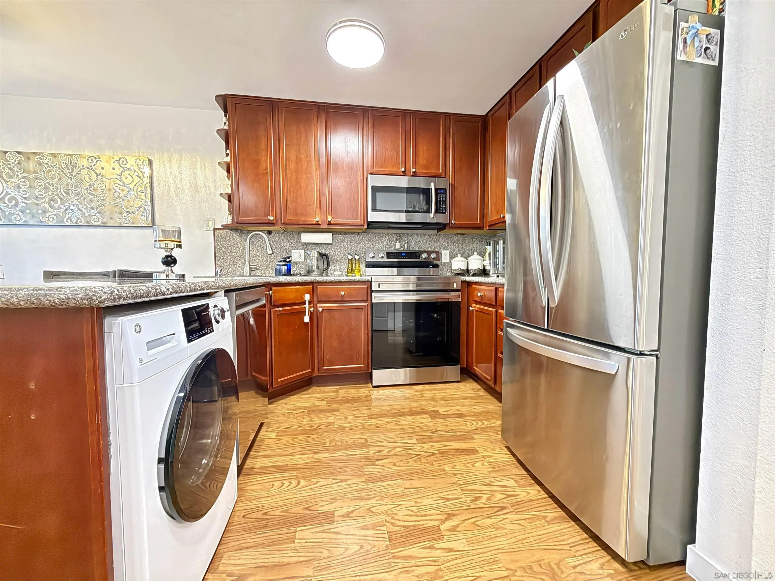 1280 West Main Street, Unit 3 El Cajon, CA 92020 - Photo 5 of 29 a kitchen with stainless steel appliances granite countertop a stove a refrigerator and a sink