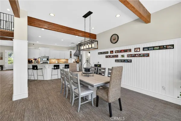 a dining room with furniture and a wooden floor