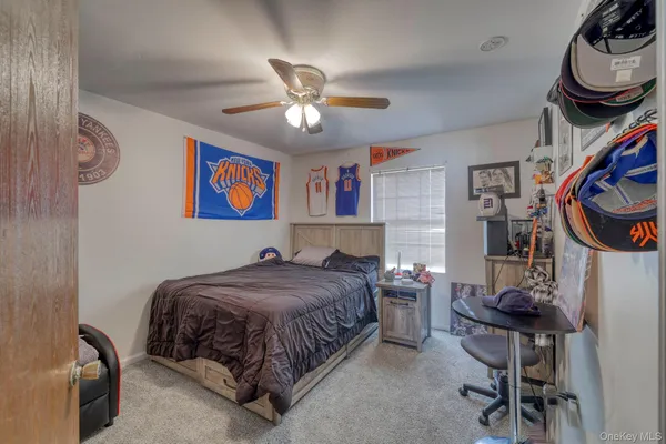a bedroom with a bed a chandelier and closet