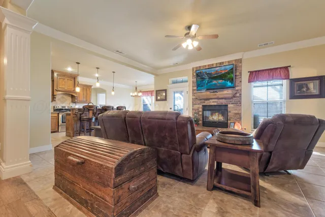 a large kitchen with kitchen island a large counter top space appliances and cabinets