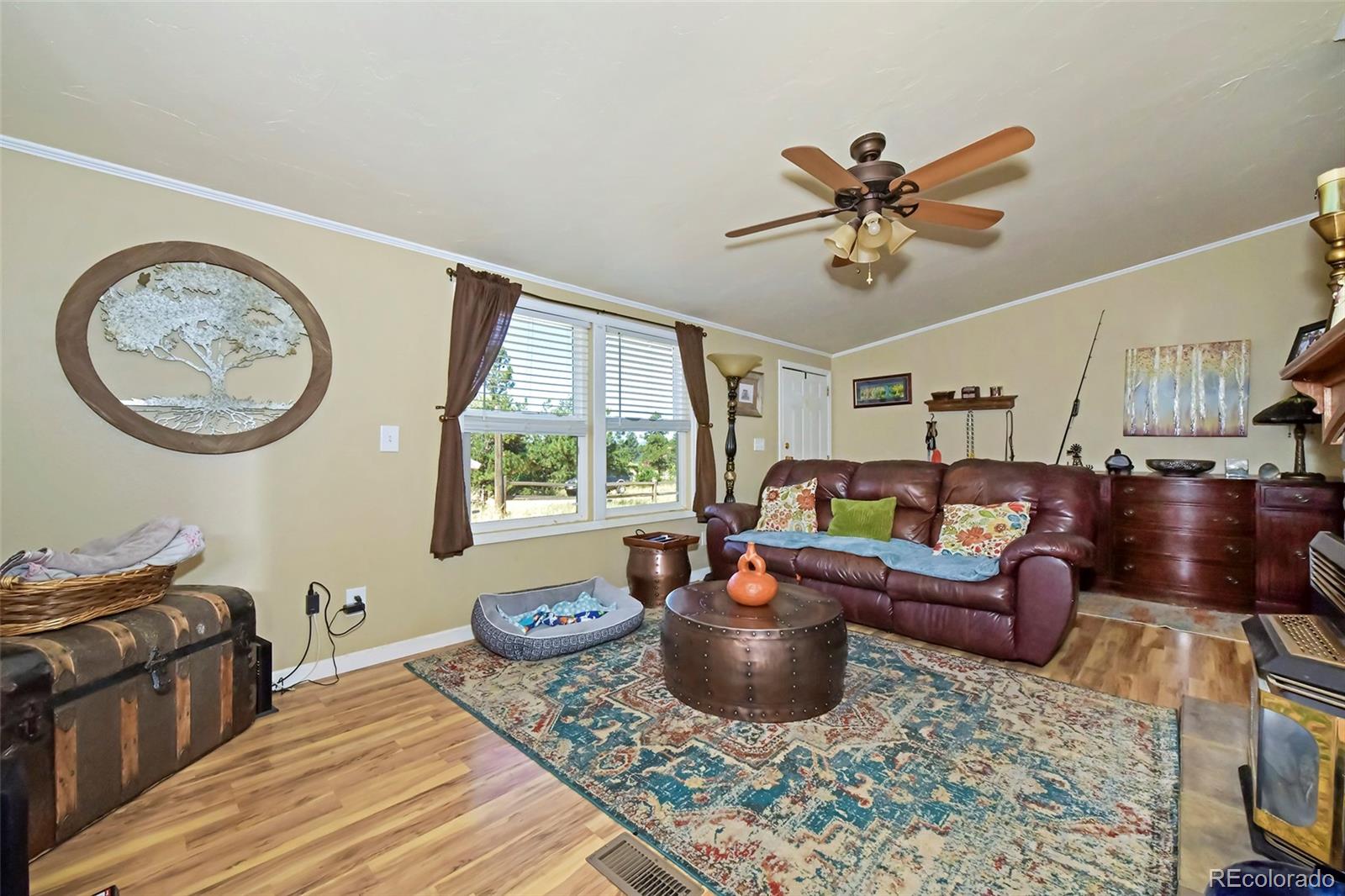44 Southpark Road Florissant, CO 80816 - Photo 16 of 39 a living room with furniture a window and a chandelier