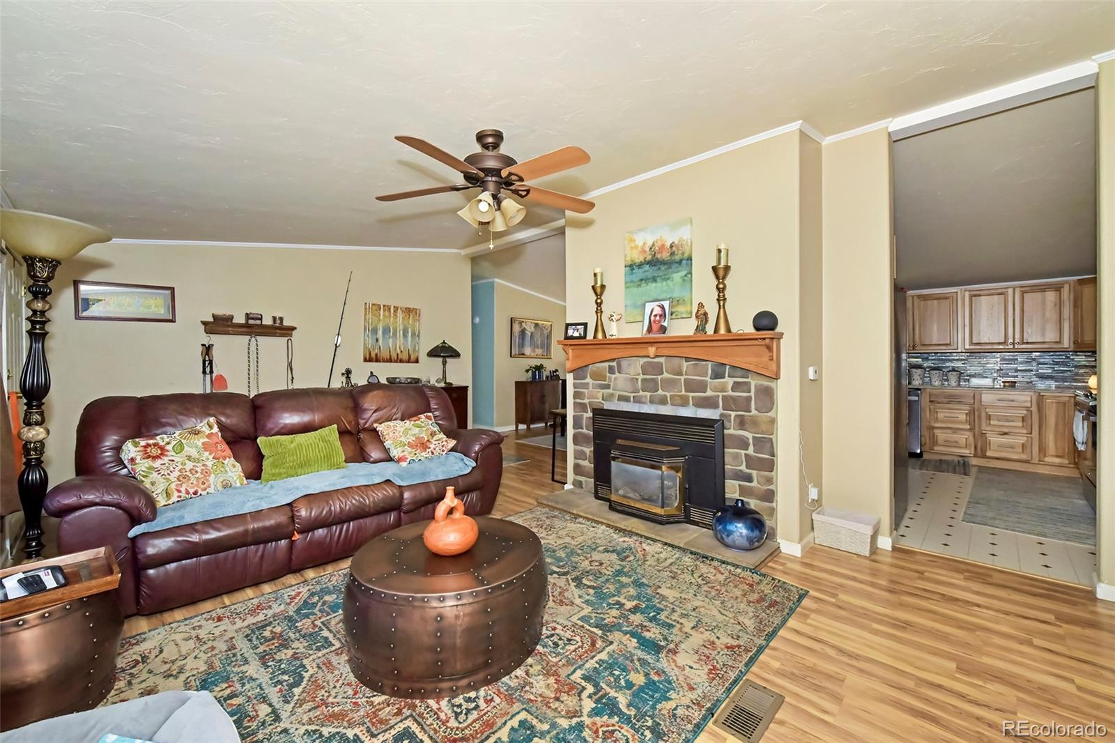 44 Southpark Road Florissant, CO 80816 - Photo 17 of 39 a living room with furniture a rug and a fireplace