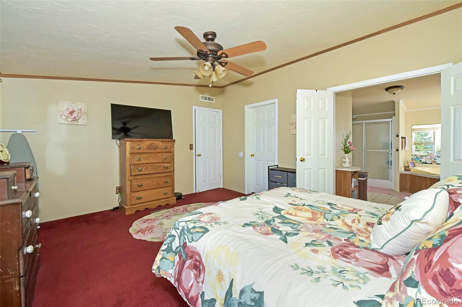 44 Southpark Road Florissant, CO 80816 - Photo 23 of 39 a bedroom with a bed and a flat screen tv