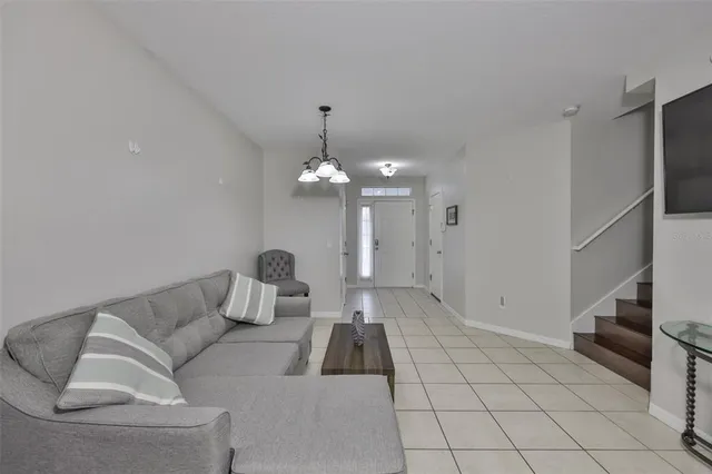 a living room with furniture and a chandelier