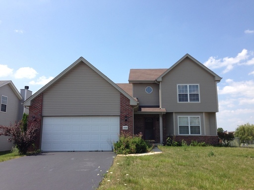 25838 Geranium Lane Monee, IL 60449 - Photo 1 of 21 a front view of a house with a yard and garage