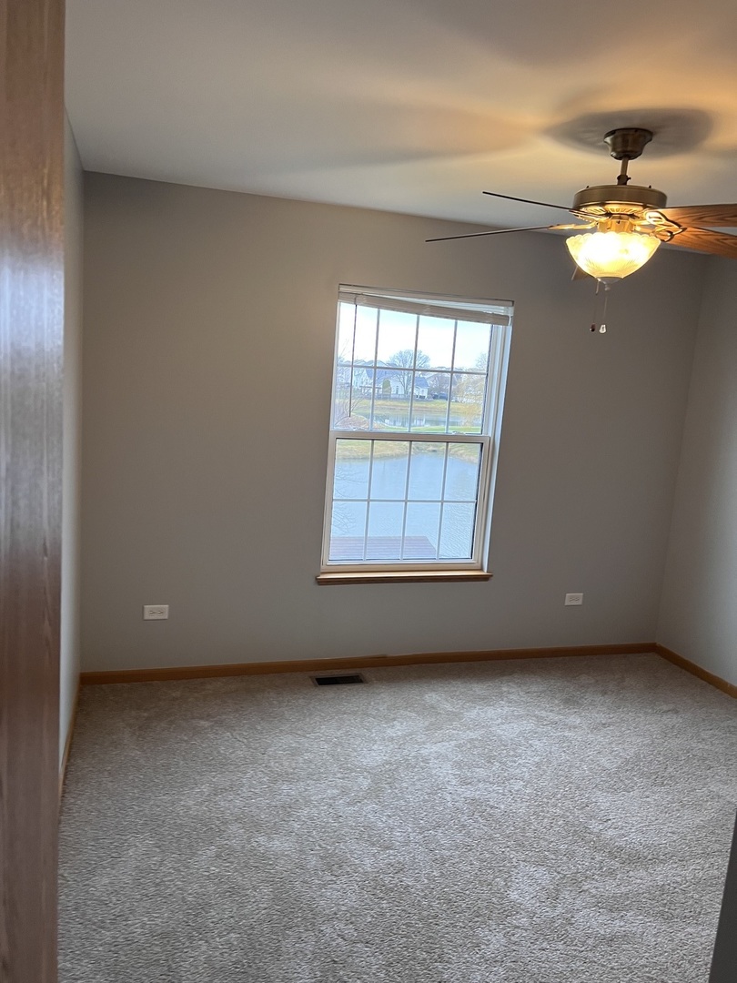 25838 Geranium Lane Monee, IL 60449 - Photo 13 of 21 an empty room with windows and chandelier fan
