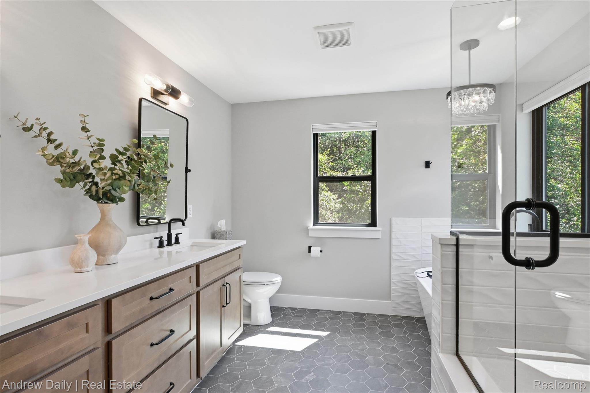 4661 Spears Road Pinckney, MI 48169 - Photo 34 of 56 Bathroom featuring a dual vanity with light wood-finish cabinetry and white countertops, a walk-in shower with glass enclosure and white tile, a soaking tub, and hexagonal floor tiling