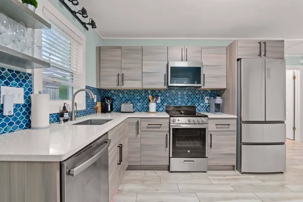 a kitchen with a sink stove and refrigerator