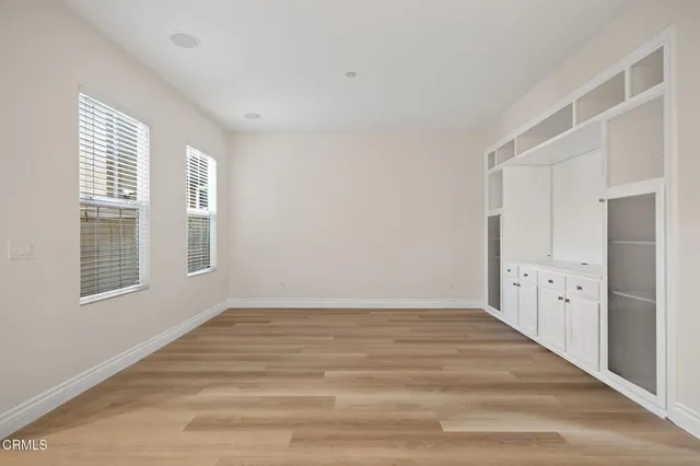 a view of empty room with wooden floor