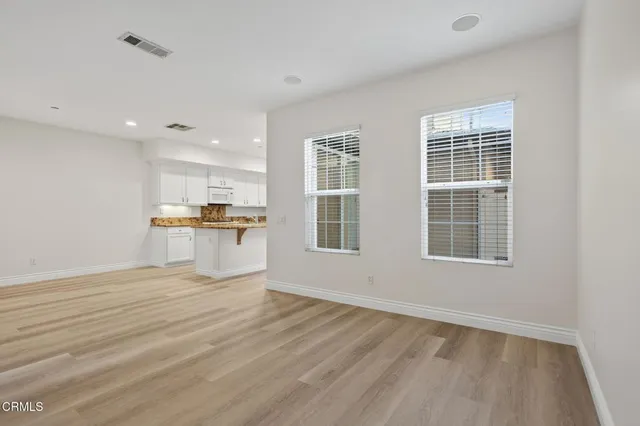 a kitchen with granite countertop a sink stove and cabinets