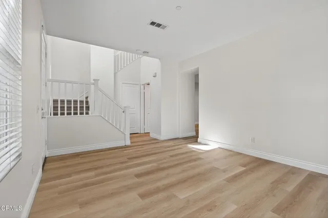 a view of kitchen with wooden floor and electronic appliances