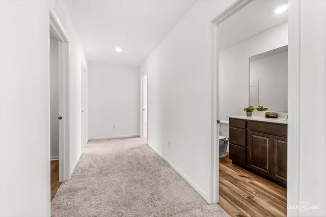 a bathroom with a granite countertop sink toilet a large mirror a bathtub and shower