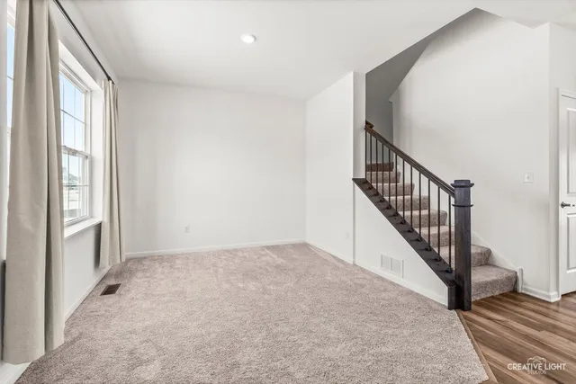 a kitchen with a sink a stove a refrigerator cabinets and a window