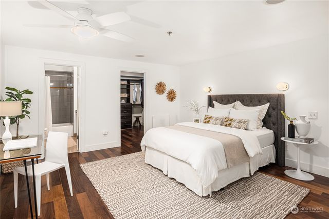 a bedroom with a bed and a chair