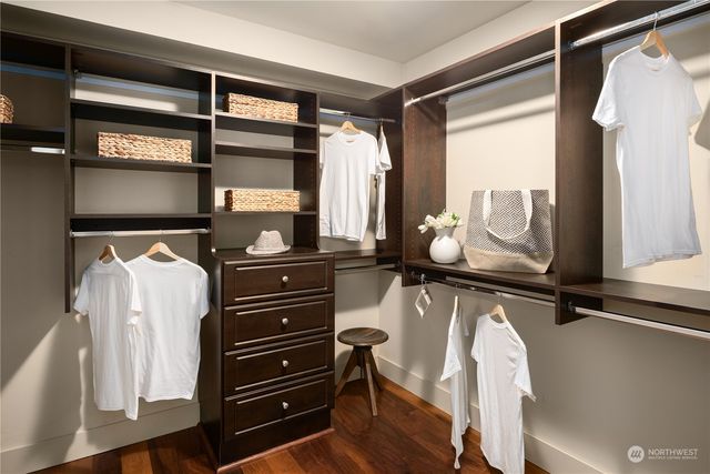 a bathroom with a sink a toilet a mirror and shower