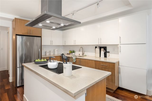 a kitchen with a sink appliances and cabinets