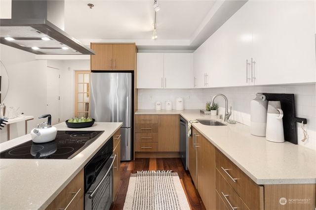 a living room with furniture and a dining table with wooden floor
