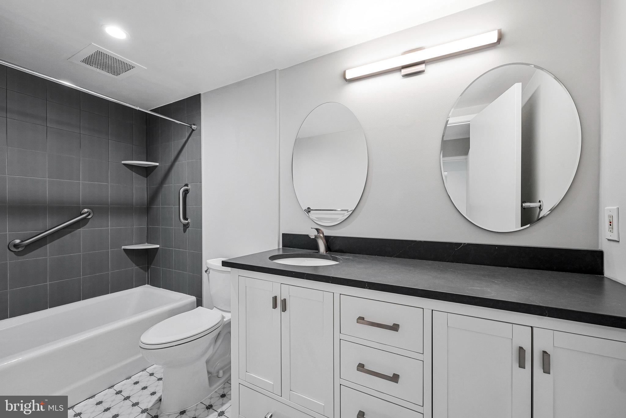 11500 Fairway Drive, Unit 402 Reston, VA 20190 - Photo 3 of 65 a bathroom with a sink a toilet and a mirror