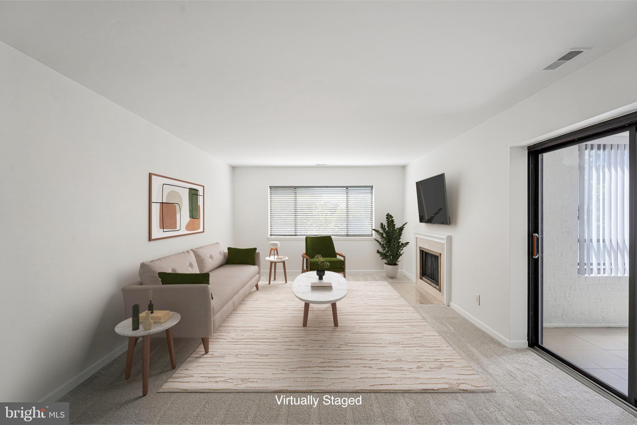 11500 Fairway Drive, Unit 402 Reston, VA 20190 - Photo 5 of 65 a living room with furniture a fireplace and a flat screen tv