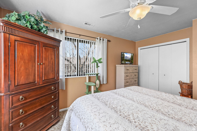1120 Canyon Road, Unit 38 Ogden, UT 84404 - Photo 18 of 24 Bedroom with ceiling fan, a closet, and carpet flooring