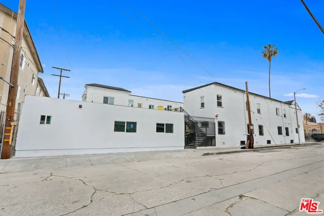 a view of a hallway with a dining table and chandelier